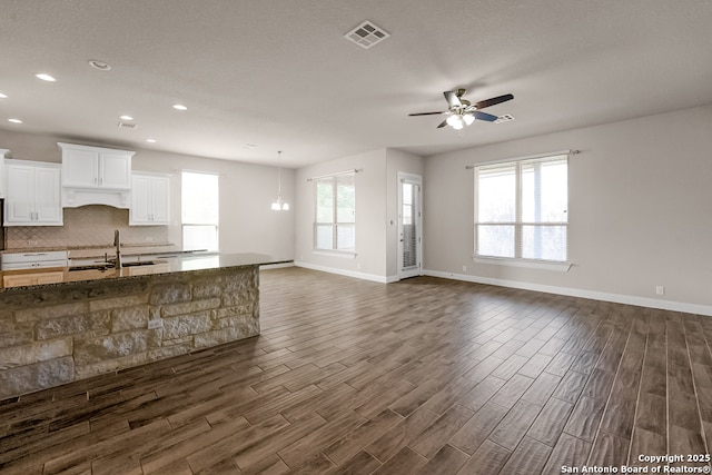 605 Albarella, Cibolo, TX 78108 - unfurnished living room with dark wood finished floors, plenty of natural light, recessed lighting, and ceiling fan