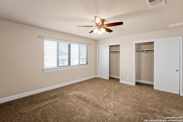 605 Albarella, Cibolo, TX 78108 - unfurnished bedroom with two closets, carpet, baseboards, and ceiling fan