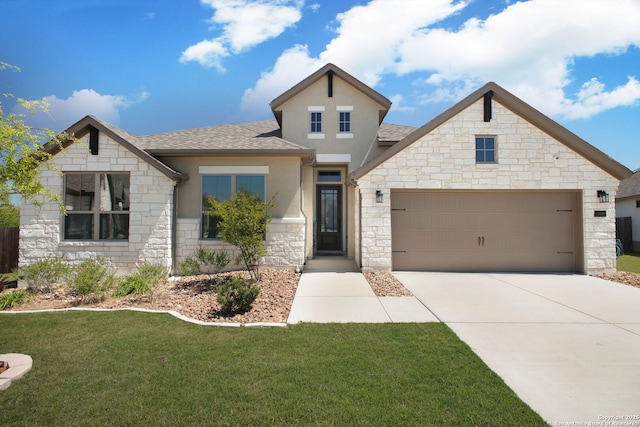 traditional-style home featuring concrete driveway, stucco siding, stone siding, a front lawn, and a garage