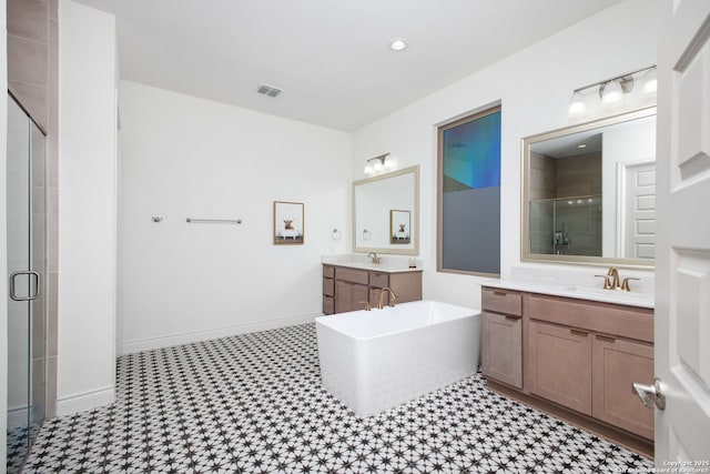 bathroom with a shower stall, visible vents, a sink, and a soaking tub