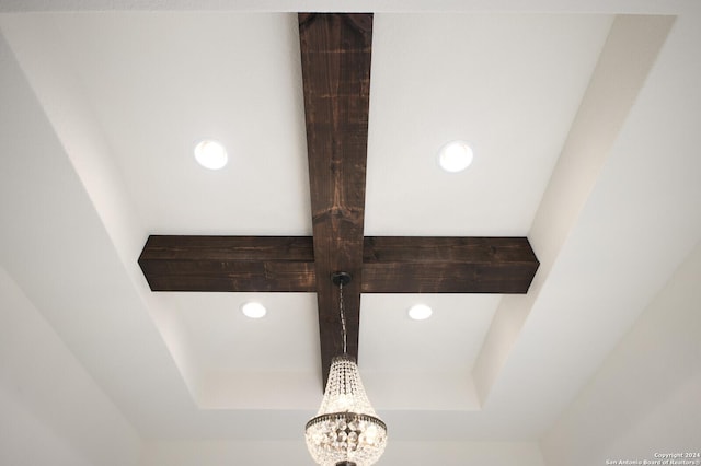 interior details with a tray ceiling, recessed lighting, and a chandelier