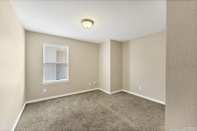 unfurnished room with baseboards and carpet flooring