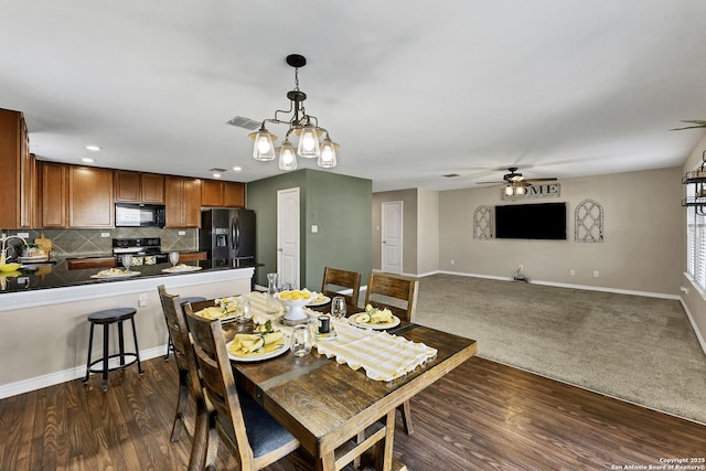 dining space featuring dark wood finished floors, baseboards, visible vents, and ceiling fan