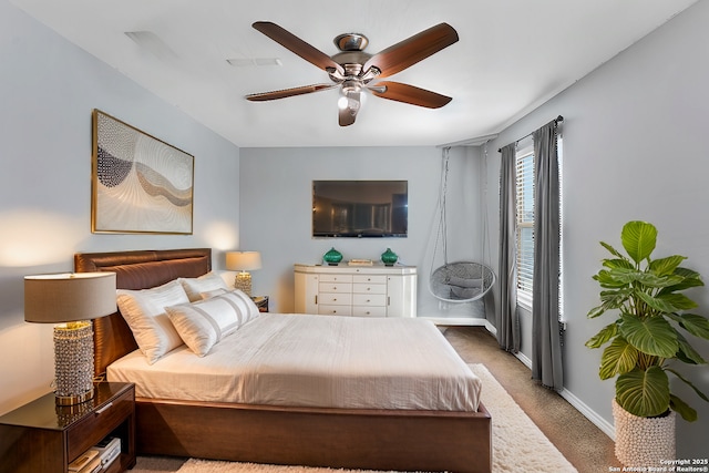 carpeted bedroom with a ceiling fan and baseboards