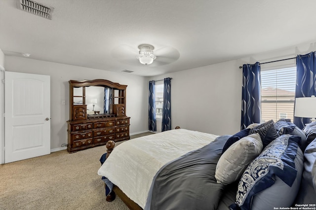 carpeted bedroom with baseboards and visible vents