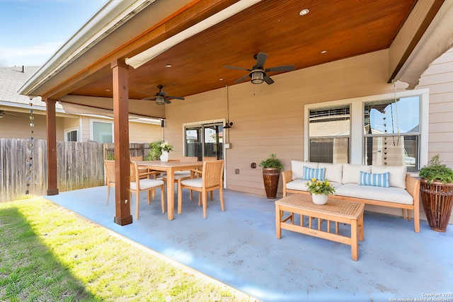 view of patio featuring outdoor dining space, outdoor lounge area, a ceiling fan, and fence