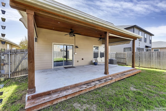 rear view of house featuring a patio area, a yard, a ceiling fan, and fence