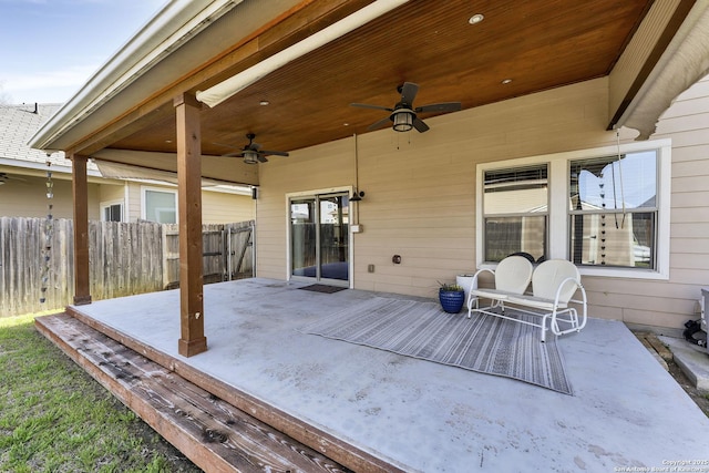 view of patio featuring a ceiling fan and fence