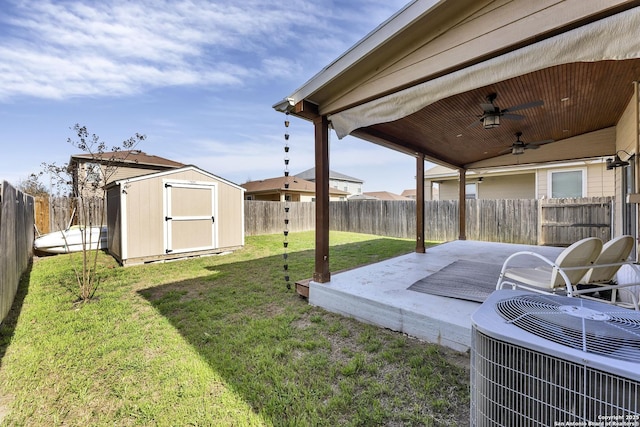 view of yard featuring a storage unit, a fenced backyard, an outdoor structure, central AC unit, and a patio area