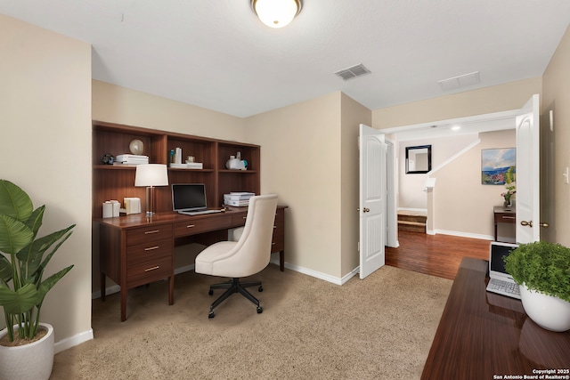 office space with visible vents and baseboards