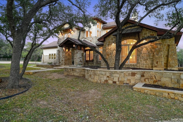 craftsman inspired home featuring stone siding and stucco siding