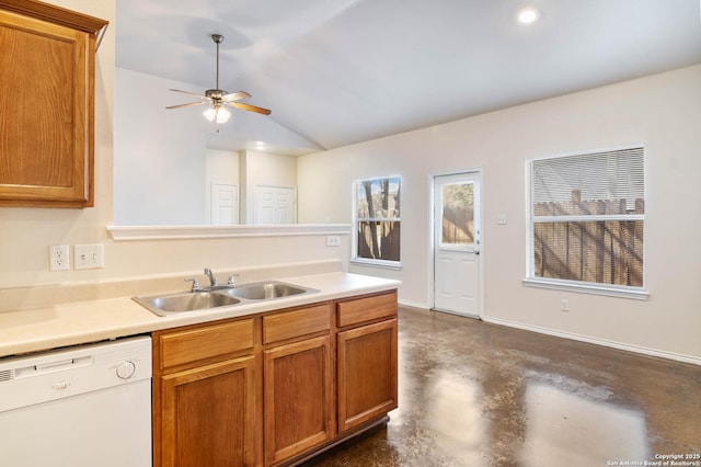 kitchen featuring finished concrete flooring, dishwasher, lofted ceiling, brown cabinets, and a sink