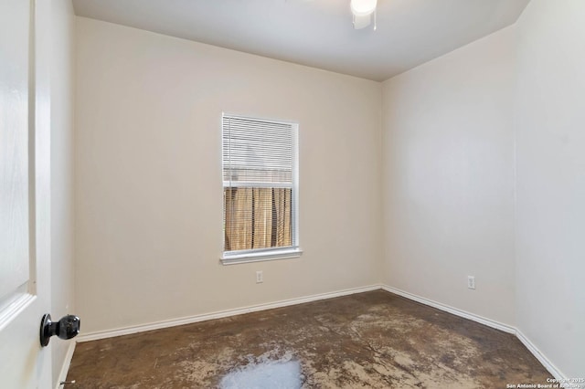 empty room with baseboards and unfinished concrete floors