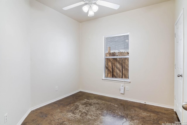 empty room with baseboards, concrete floors, and a ceiling fan