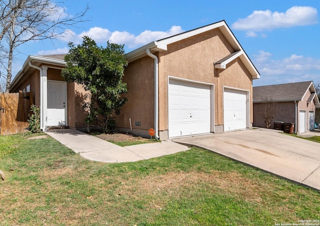 ranch-style house featuring stucco siding, a garage, a front lawn, and fence