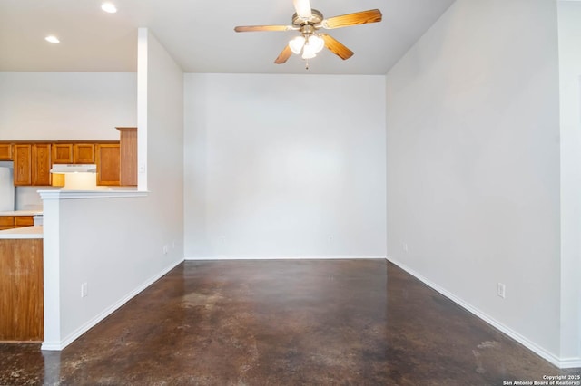 empty room featuring baseboards, finished concrete flooring, and a ceiling fan