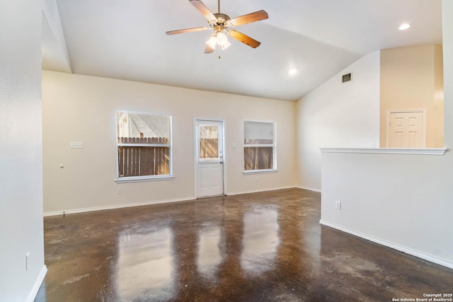 spare room with baseboards, ceiling fan, finished concrete flooring, and lofted ceiling