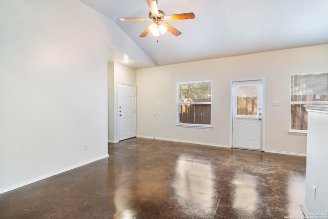 empty room featuring baseboards, high vaulted ceiling, concrete flooring, and a ceiling fan