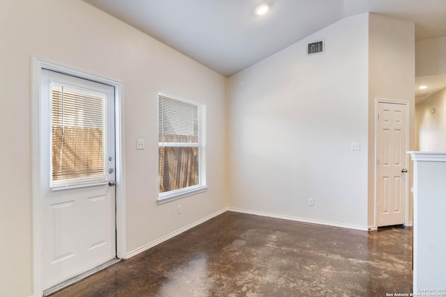 interior space featuring vaulted ceiling, visible vents, baseboards, and finished concrete floors