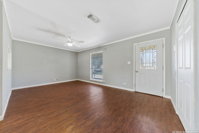 foyer with visible vents, plenty of natural light, dark wood-style floors, and ornamental molding