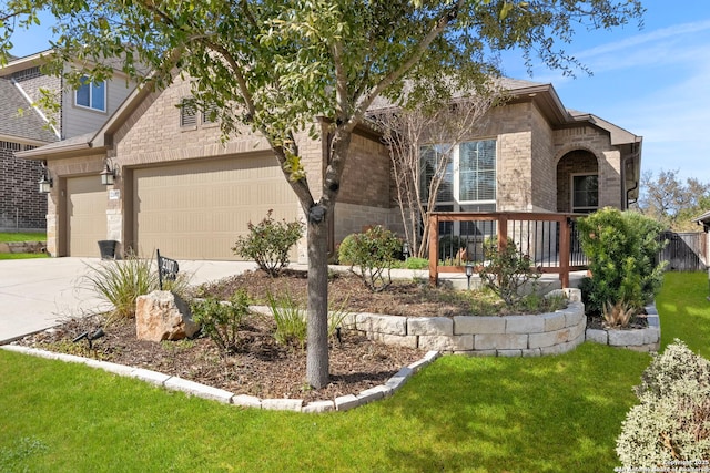 view of front facade with a front yard, brick siding, a garage, and driveway