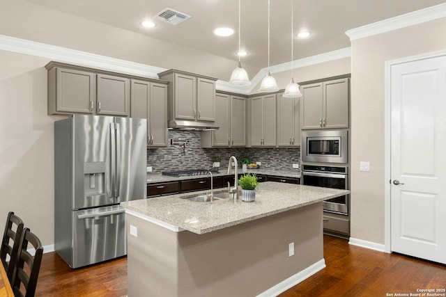 kitchen featuring visible vents, a sink, decorative backsplash, gray cabinetry, and stainless steel appliances