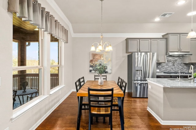 interior space with visible vents, baseboards, dark wood finished floors, ornamental molding, and recessed lighting