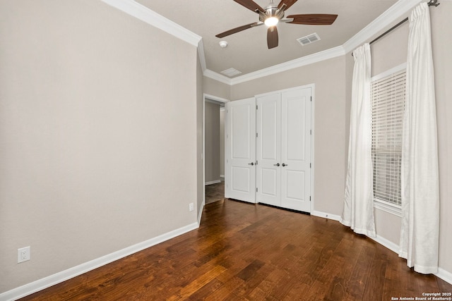 unfurnished bedroom featuring dark wood-type flooring, baseboards, and ornamental molding