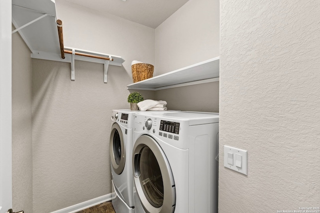 laundry room with laundry area, washing machine and dryer, baseboards, and a textured wall