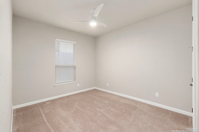 unfurnished room with a ceiling fan, light colored carpet, and baseboards