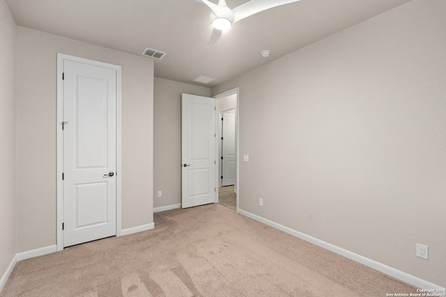 unfurnished bedroom featuring visible vents, carpet floors, baseboards, and ceiling fan