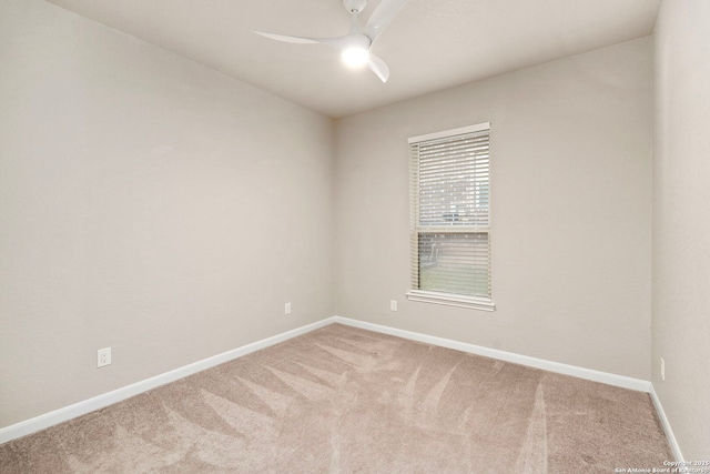 carpeted empty room with baseboards and ceiling fan