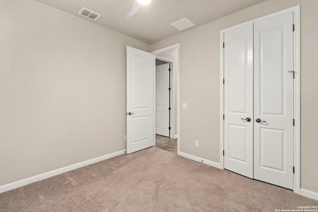 unfurnished bedroom with visible vents, ceiling fan, baseboards, carpet floors, and a closet