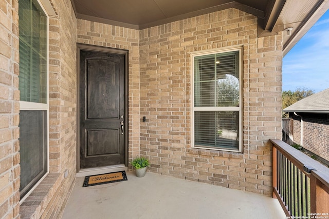 entrance to property featuring brick siding