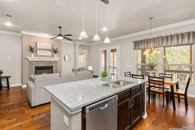 kitchen featuring stainless steel dishwasher, dark wood-style floors, visible vents, and a sink