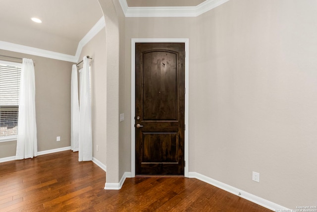 entryway with ornamental molding, baseboards, and hardwood / wood-style floors