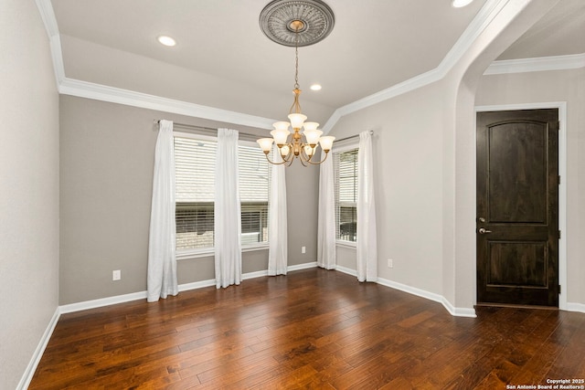 unfurnished dining area featuring a wealth of natural light, baseboards, wood-type flooring, and crown molding