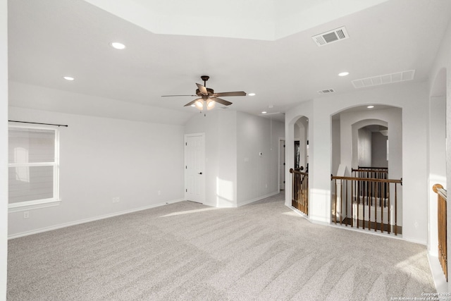 unfurnished room with recessed lighting, arched walkways, and visible vents