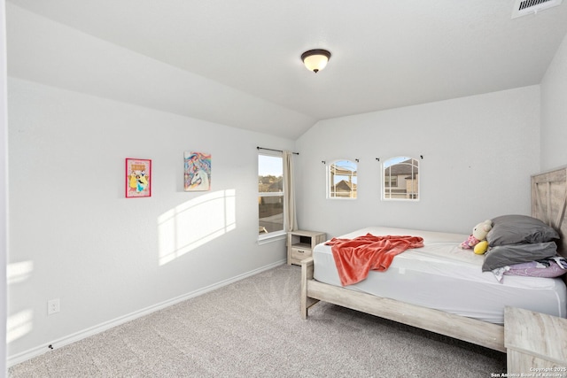 bedroom with visible vents, baseboards, carpet flooring, and vaulted ceiling