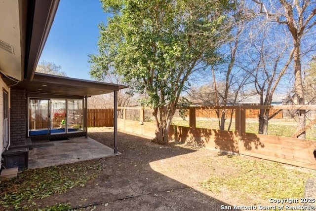 view of yard with a patio area and a fenced backyard