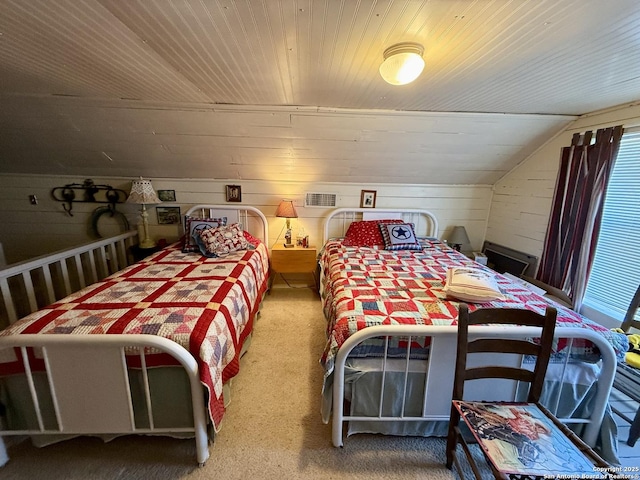 carpeted bedroom with lofted ceiling, wooden walls, wood ceiling, and visible vents