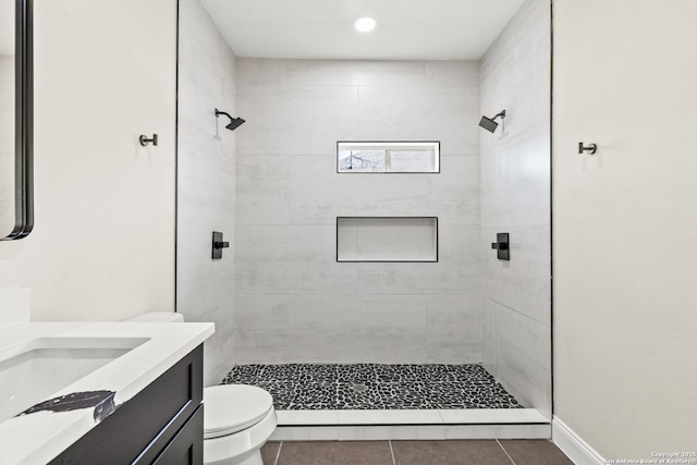 full bathroom featuring tile patterned floors, vanity, toilet, and a shower stall