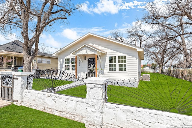 bungalow-style house featuring a front yard, a gate, and a fenced front yard