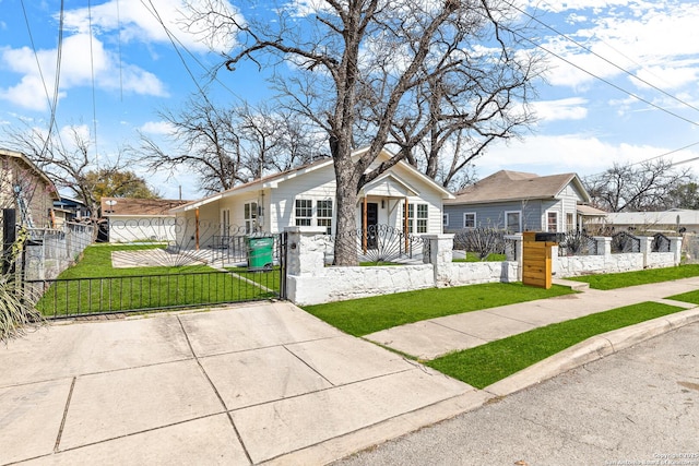 bungalow with a fenced front yard, covered porch, a front lawn, and a gate