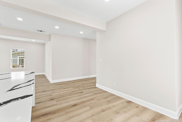 unfurnished room featuring recessed lighting, baseboards, visible vents, and light wood-type flooring