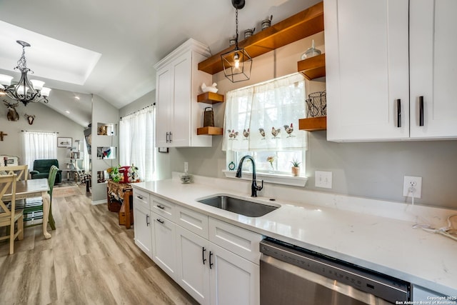 kitchen featuring open shelves, a sink, white cabinetry, dishwasher, and vaulted ceiling