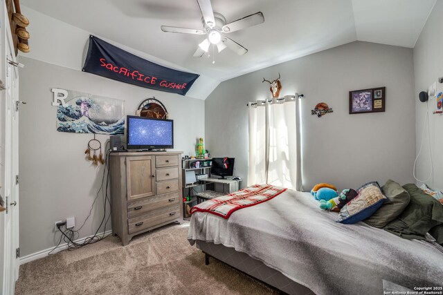 bedroom featuring light carpet, baseboards, a ceiling fan, and lofted ceiling