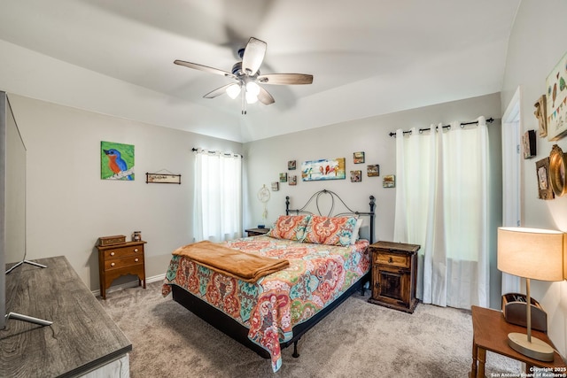 bedroom with a ceiling fan, lofted ceiling, and light colored carpet