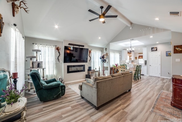 living room with light wood-type flooring, visible vents, and a healthy amount of sunlight