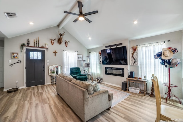 living room featuring plenty of natural light, visible vents, and light wood finished floors